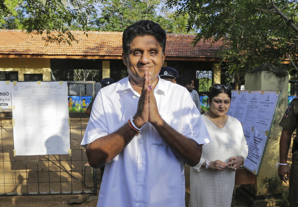 Presidential candidate of Sri Lanka's governing party Sajith Premadasa leaves a polling station after casting his vote in Weerawila, Sri Lanka, Saturday, Nov. 16 , 2019. A convoy of buses carrying Muslim voters traveling in northern Sri Lanka was attacked by gunfire and stones, and blocked by burning tires, around midnight on Saturday hours before polls opened in Sri Lanka’s presidential election, according to Colombo-based Centre for Monitoring Election Violence. (AP Photo/Chamila Karunarathne )