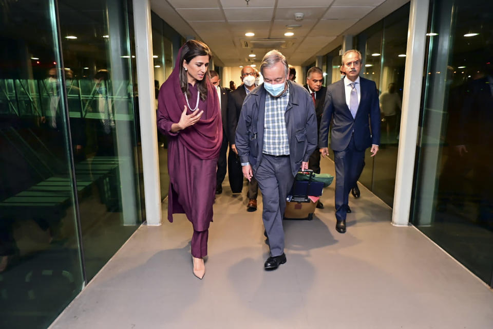 In this handout photo released by Pakistan Foreign Ministry Press Service, U.N. Secretary-General Antonio Guterres, center, is received on his arrival by Deputy Foreign Minister Hina Rabbani Khar, left, in the airport in Islamabad, Pakistan, Friday, Sept. 9, 2022. Guterres appealed to the world to help Pakistan after arriving in the country Friday to see damage from the record floods that have killed hundreds and left more than half a million people homeless and living in tents under the open sky. (Pakistan Foreign Ministry Press Service via AP)