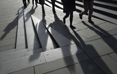 Workers are seen walking during the lunch hour in the City of London, in Britain, January 21, 2016. REUTERS/Toby Melville