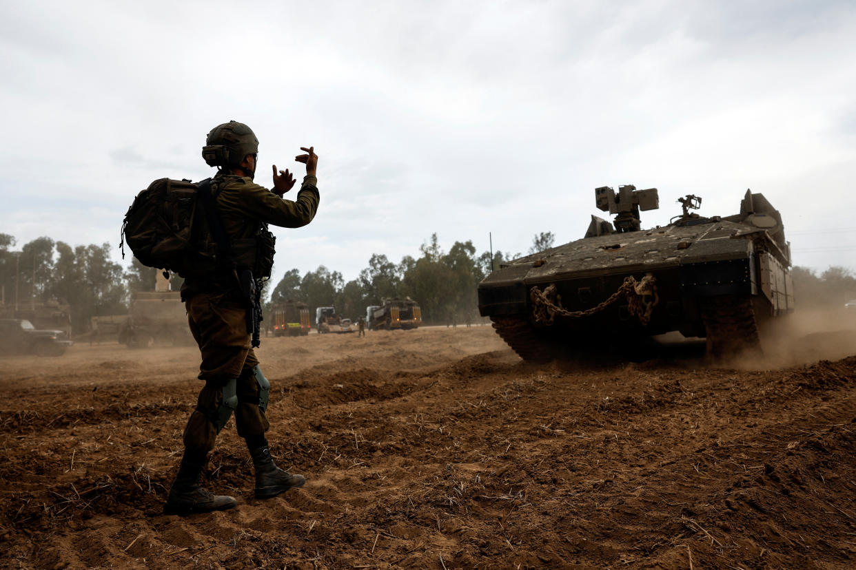 An Israeli soldier directs an Armoured Personnel Carrier (APC) at the Israeli side of the Gaza border, as violence around the nearby Gaza Strip mounts following a mass-rampage by armed Palestinian infiltrators, October 9, 2023. REUTERS/Amir Cohen oil prices