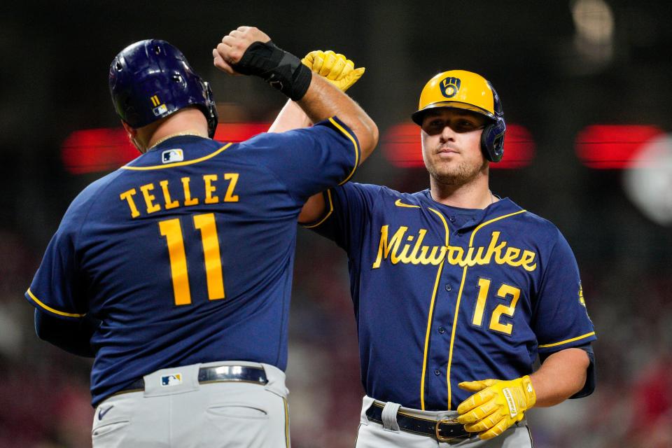 Brewers rightfielder Hunter Renfroe gets a forearm smash from Rowdy Tellez after hitting a two-run home run, his second longball of the night against the Reds, during the fifth inning Saturday.