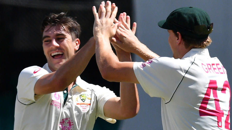 Australian paceman Pat Cummins celebrates his wicket of Indian captain Ajinkya Rahane with teammates on day three of the third cricket Test match at Sydney Cricket Ground. (Photo by SAEED KHAN/AFP via Getty Images)