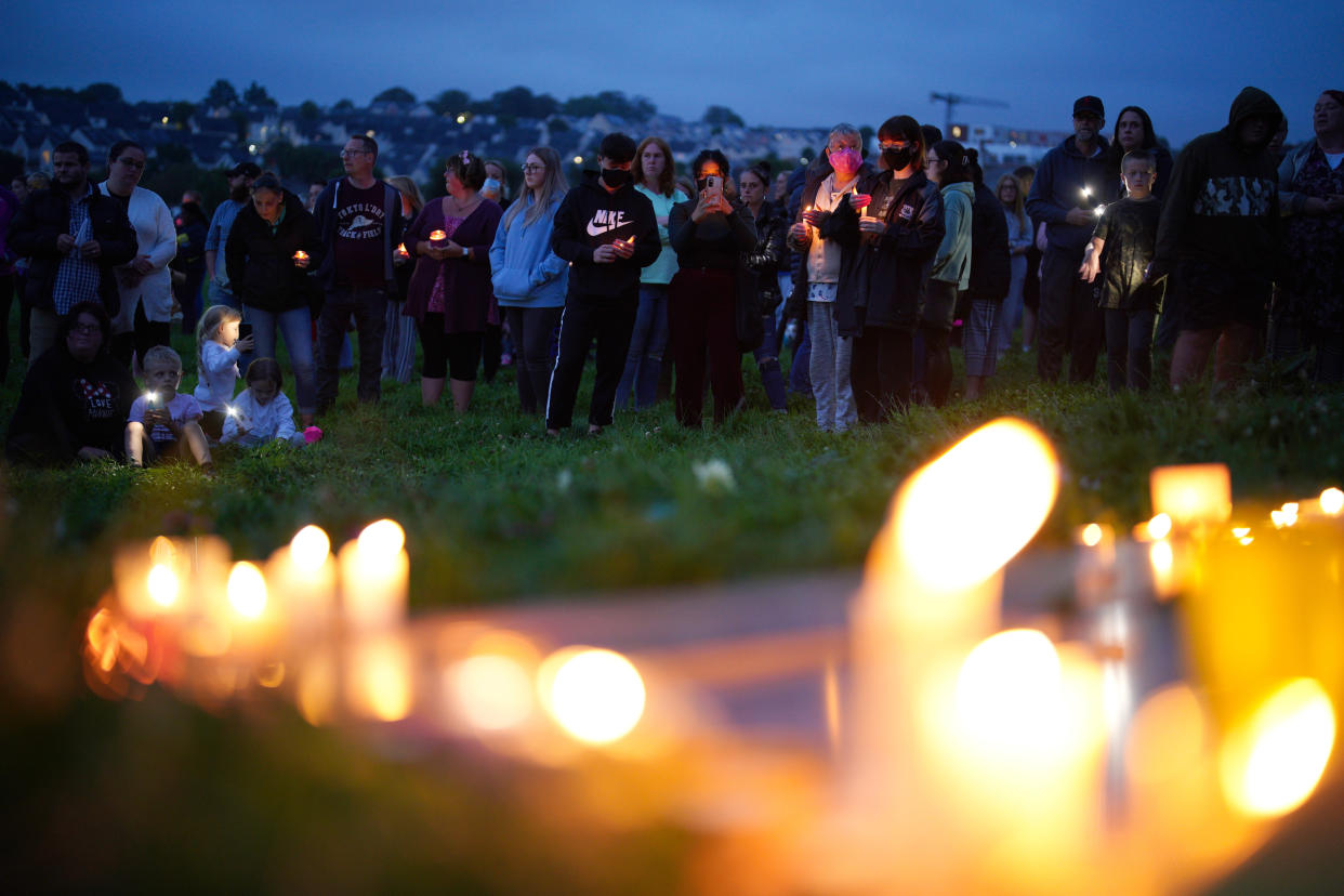 Members of the public attend a vigil for the victims of the Keyham mass shooting on 13 August last year. (PA)