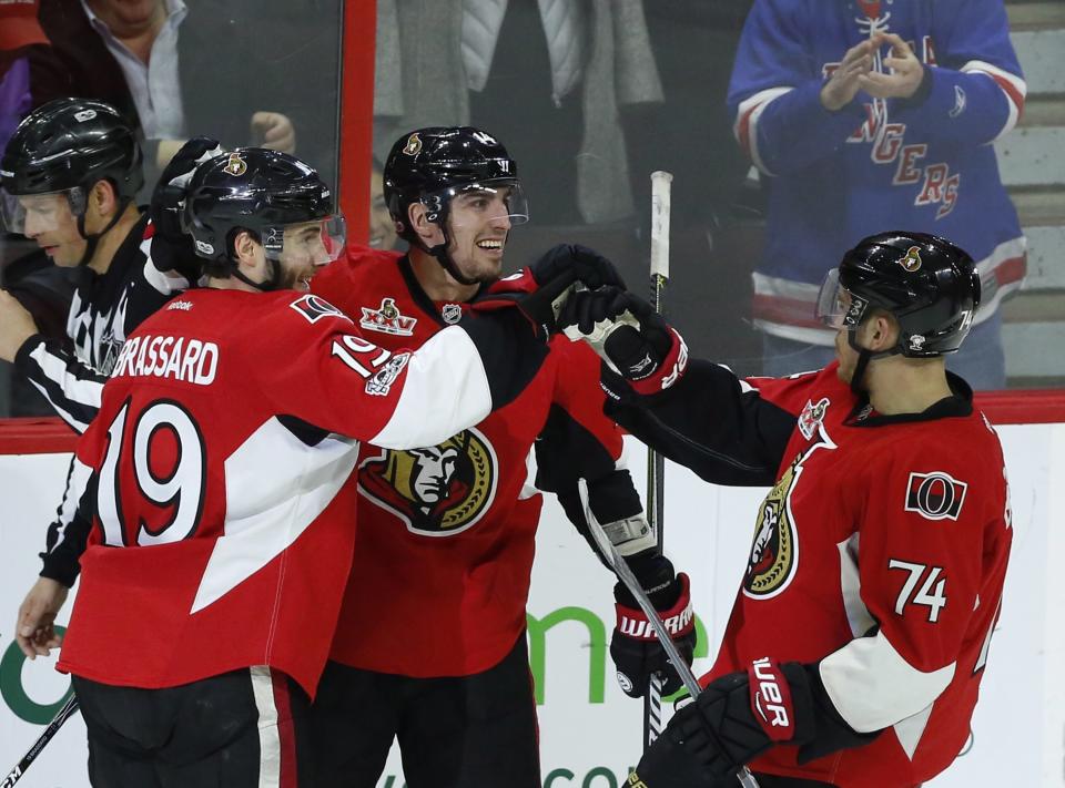 Ottawa Senators' Derick Brassard (19) celebrates his goal against the New York Rangers with teammates Alexandre Burrows (14) and Mark Borowiecki (74) during the second period of an NHL hockey game in Ottawa on Saturday April 8, 2017. (Fred Chartrand/The Canadian Press via AP)