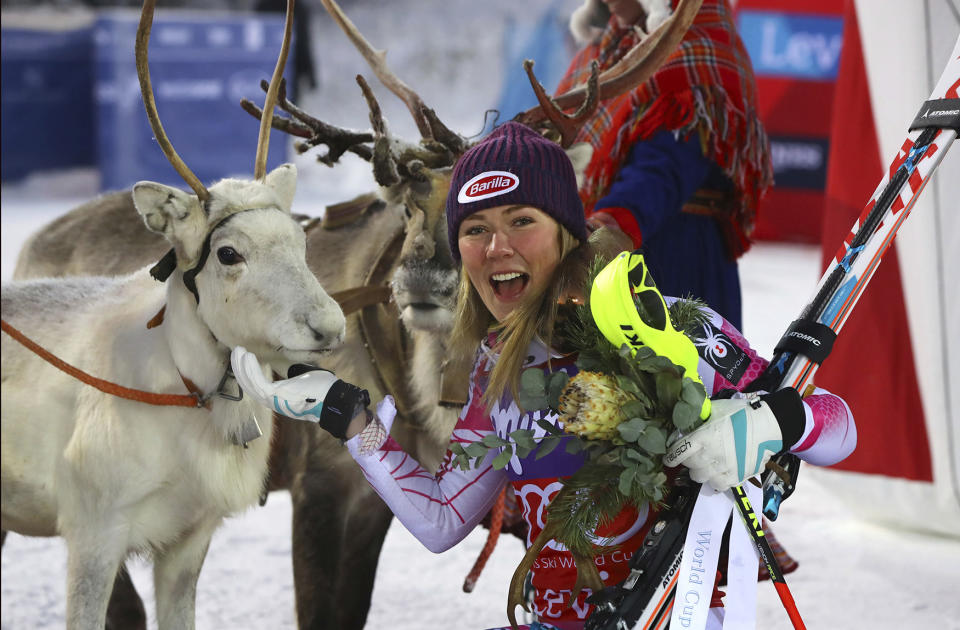 Mikaela Shiffrin pets a reindeer