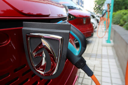 FILE PHOTO: A Baojun E100 all-electric battery car is seen while it is being charged in the parking lot in front of a Baojun NEV Experience Center store in Liuzhou, Guangxi Zhuang Autonomous Region, China, November 8, 2017. Picture taken November 8, 2017. REUTERS/Norihiko Shirouzu/File Photo