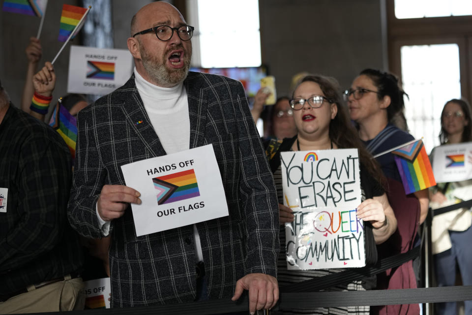 Brian Sullivan, left, protests against a bill that would ban the Pride Flag from being displayed in schools, outside the House chamber before a legislative session Monday, Feb. 26, 2024, in Nashville, Tenn. (AP Photo/George Walker IV)
