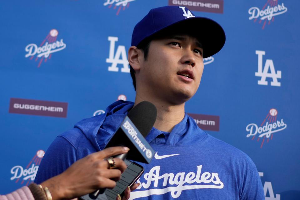 Los Angeles Dodgers' Shohei Ohtani speaks to media at Camelback Ranch in Phoenix, Friday, Feb. 9, 2024, on the first day of spring training baseball workouts for the Dodgers. (AP Photo/Carolyn Kaster)