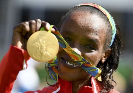 2016 Rio Olympics - Athletics - Victory Ceremony - Women's Marathon Victory Ceremony - Sambodromo - Rio de Janeiro, Brazil -14/08/2016. Jemima Sumgong (KEN) of Kenya poses with her gold medal REUTERS/Dylan Martinez