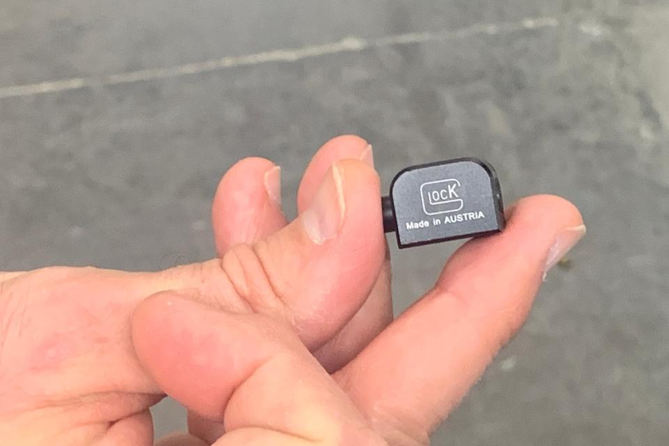 The Glock “switch” quickly attached to a handgun, converting the firearm from shooting one bullet per trigger squeeze to having the capability of firing until the trigger is released, pictured, Wednesday, Feb. 22, 2023, at Great Oaks Firing Range in Sharonville, Ohio.