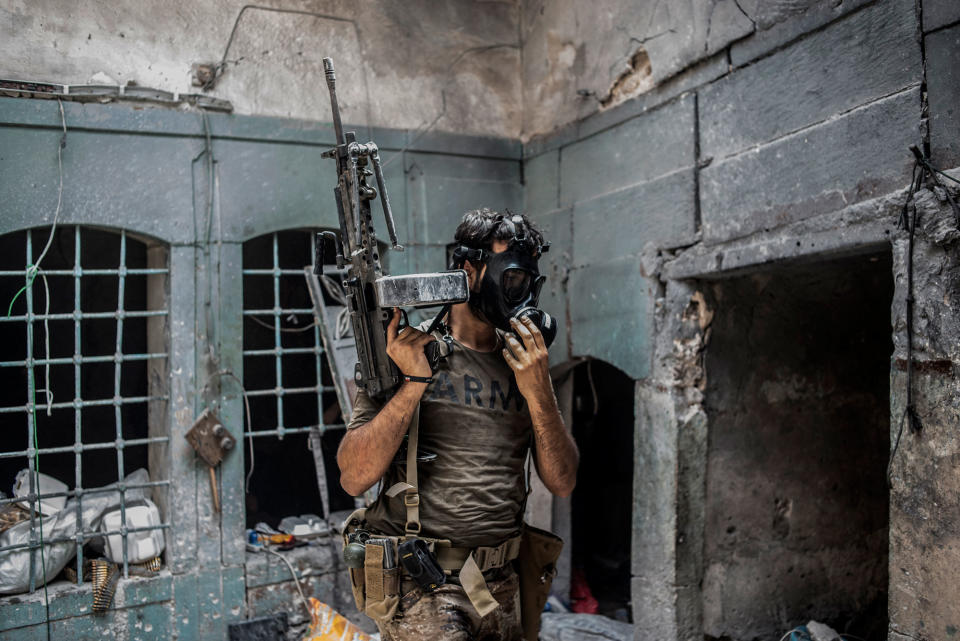 <p>An Iraqi Special Operation Forces (ISOF) soldier wears a gas mask during an Islamic State gas attack in the Islamic State occupied Old City district where heavy fighting continues on July 8, 2017 in Mosul, Iraq. Iraqi forces continue to encounter stiff resistance from Islamic State with improvised explosive devices (IED’s), suicide bombers, heavy mortar fire, gas attacks and snipers hampering their advance. (Photo: Martyn Aim/Corbis via Getty Images) </p>