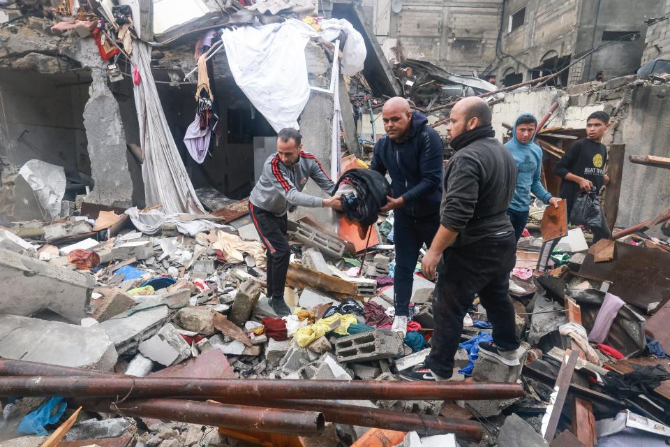 Palestinians inspect the damages amid the rubble following Israeli bombardment in Rafah in the southern Gaza Strip on Dec. 13, 2023, as battles continue between Israel and the Palestinian militant group Hamas. Israel came under pressure on Dec. 13 from its allies over its war in Gaza, with key backer the United States criticizing its bombing in response to the October 7 attacks as "indiscriminate."