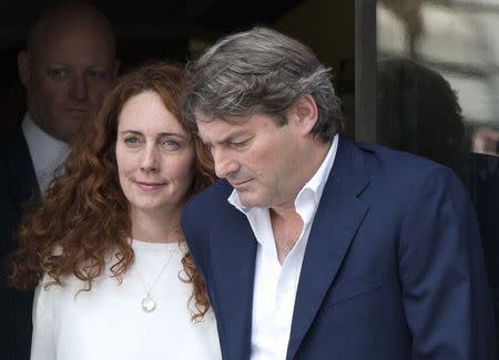 Former News International chief executive Rebekah Brooks and her husband Charlie leave the Old Bailey courthouse in London June 24, 2014. REUTERS/Neil Hall