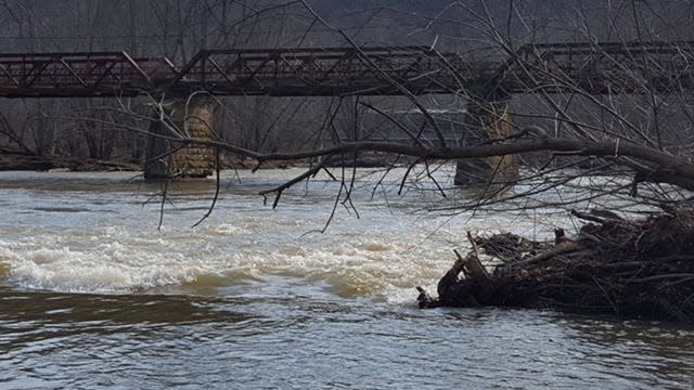 A tree limb hangs out over a downstream V on the right side of what's left of Brinkhaven Dam. The safest place to breach the dam. It was winter when this photo was taken and I opted not to try shooting the dam with a fully loaded canoe, the only time in 43 years of paddling the Mohican River that I portaged the dam.