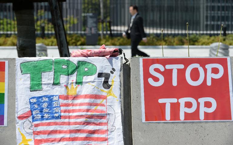 Placards are placed on the wall during a sit-in protest against the Trans Pacific Partnership (TPP) trade deal in front of the parliament building in Tokyo on April 23, 2014