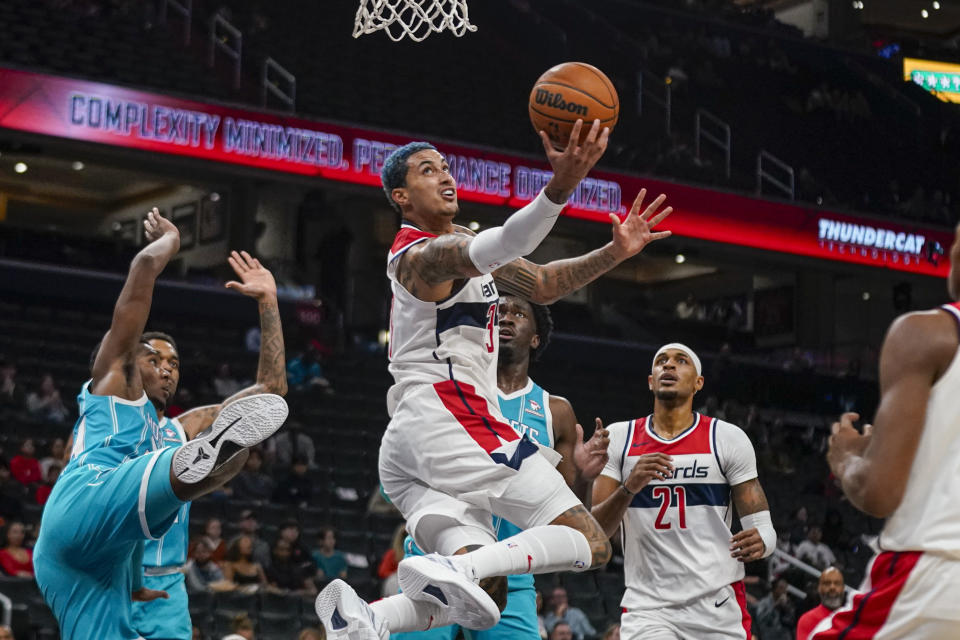 Washington Wizards forward Kyle Kuzma, center, shoots after being fouled by Charlotte Hornets forward Brandon Miller, left, during the first half of an NBA basketball preseason game Thursday, Oct. 12, 2023, in Washington. (AP Photo/Andrew Harnik)