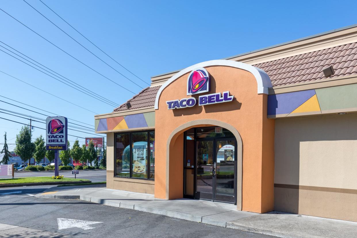 Exterior of Taco Bell fast-food restaurant with sign and logo.