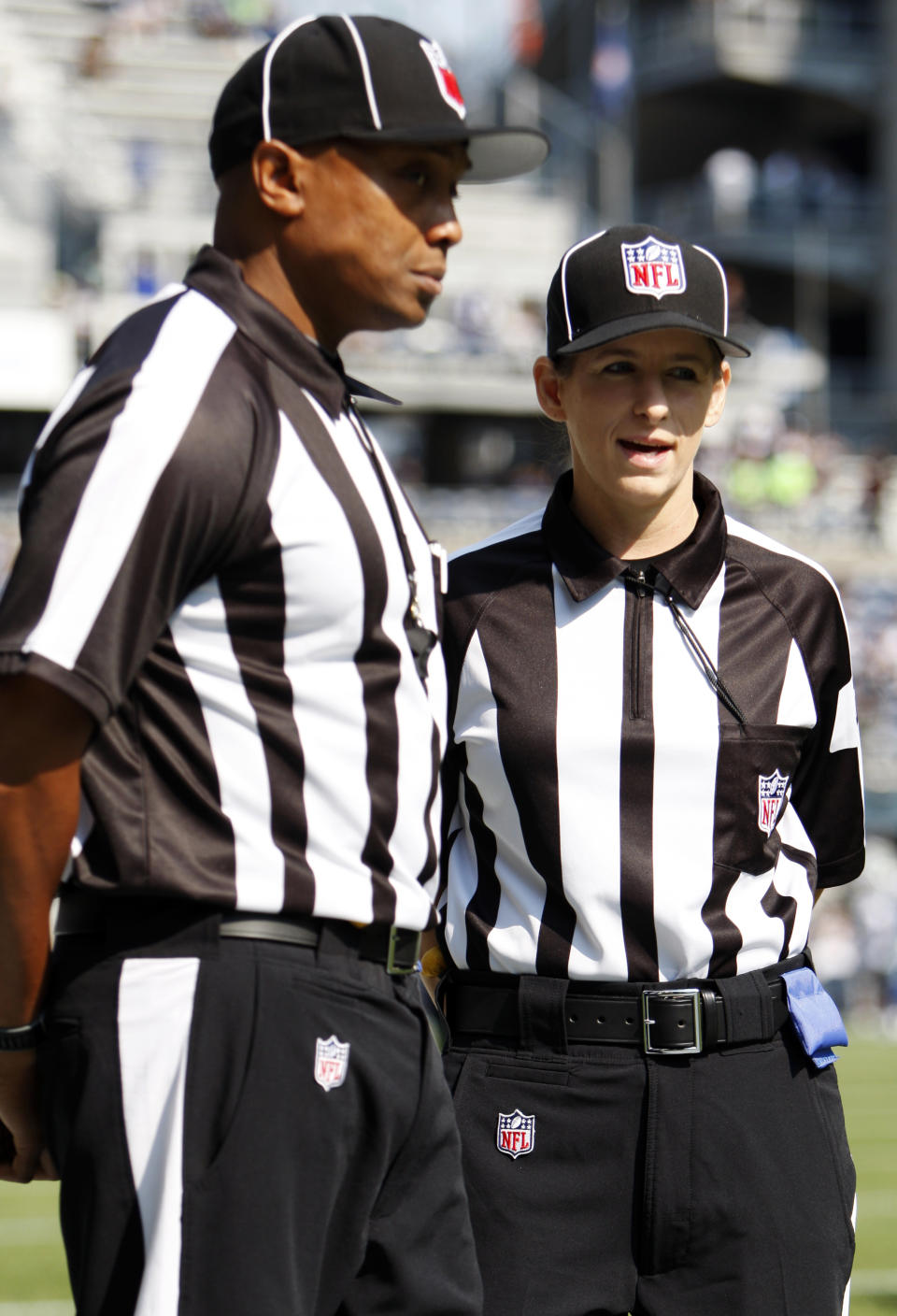 Official Shannon Eastin, right, talks with another official before an NFL football game between the Dallas Cowboys and Seattle Seahawks, Sunday, Sept. 16, 2012, in Seattle. (AP Photo/Kevin P. Casey)