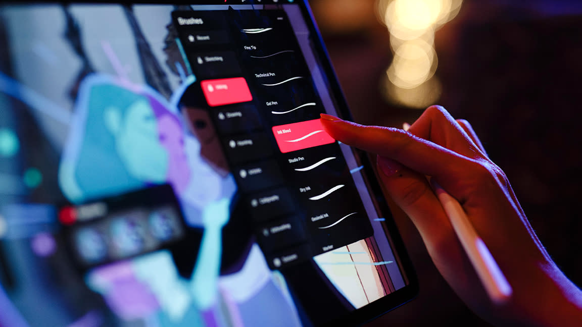  Procreate Dreams everything you need to know; a person taps an animation app on an iPad. 