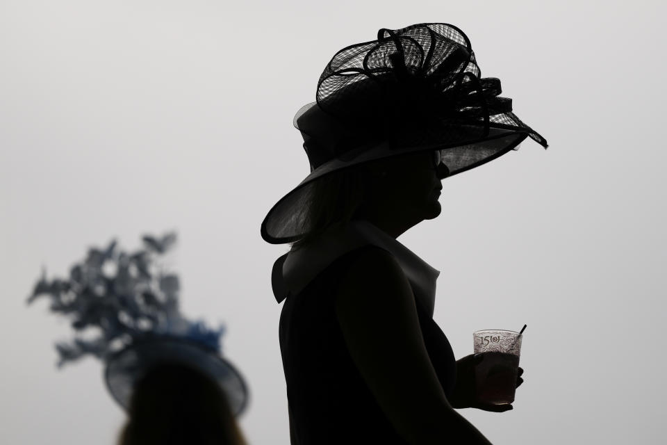 Race fans walk though the stands at Churchill Downs before the 150th running of the Kentucky Derby horse race Saturday, May 4, 2024, in Louisville, Ky. (AP Photo/Charlie Riedel)