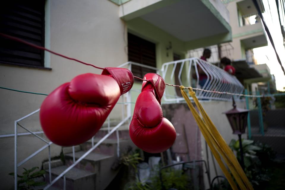 In this Jan. 19, 2017 photo, Idamelys Moreno's boxing gloves hang on a line to dry, after a training session in Havana, Cuba. Women were first allowed to box at the Olympics during the 2012 Summer Olympics but they are still not allowed to box in Cuba. (AP Photo/Ramon Espinosa)