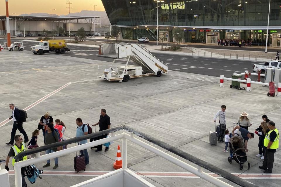 Dodgy character: Simon Calder (left, with backpack) on the apron at Ramon airport in southern Israel: Julian Eccles