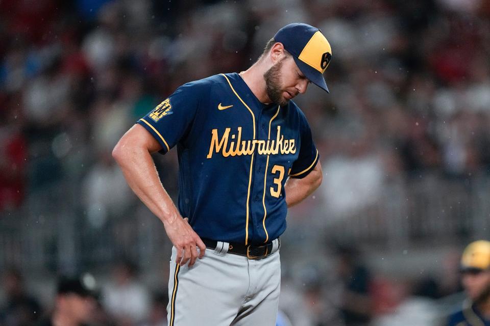 Brewers starting pitcher Adrian Houser waits on the mound for manager Craig Counsell to relieve him in the fifth inning of a their game against the Braves on Friday night..