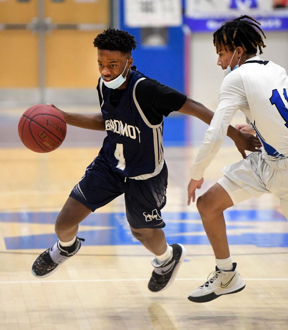 Michael Desir of Monomoy drives on Sean Gonsalves of Mashpee in this game from February 2022.