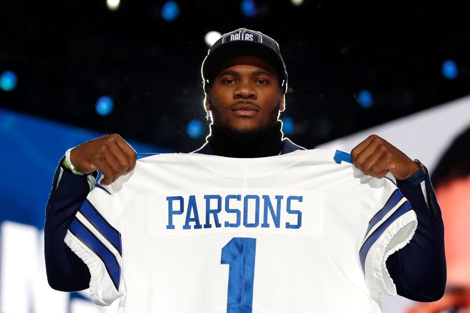 Penn State linebacker Micah Parsons holds a team jersey after the was chosen by the Dallas Cowboys with the 12th pick in the NFL football draft Thursday, April 29, 2021, in Cleveland.