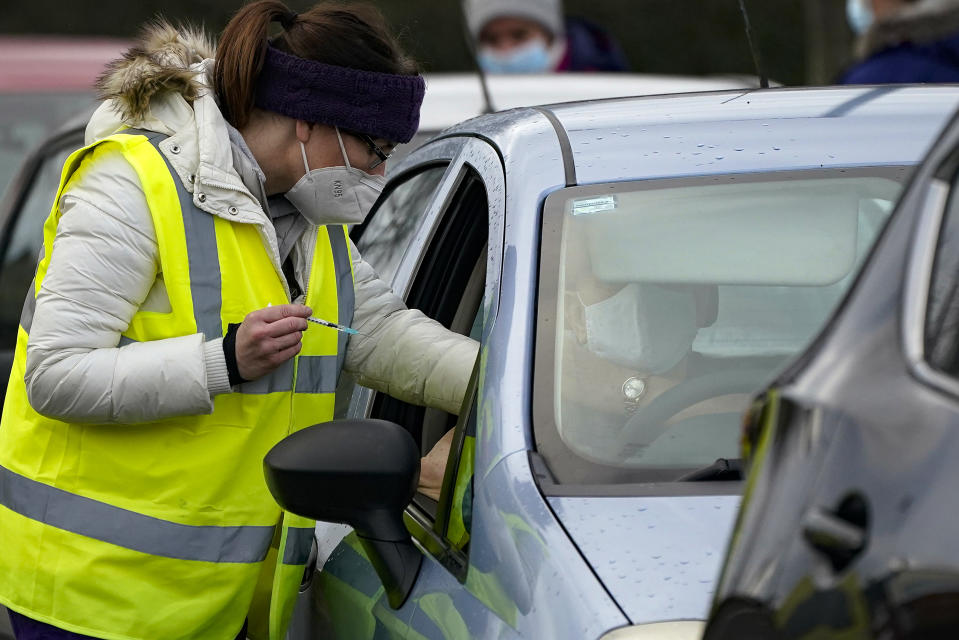 HYDE, ENGLAND - JANUARY 08: A man sits in his car as he is administered the Pfizer/BioNTech coronavirus vaccine at a drive-thru COVID-19 vaccination centre at Hyde Leisure Centre on January 08, 2021 in Hyde, England. The coronavirus drive-through vaccine centre is believed to be the first in the world. (Photo by Christopher Furlong/Getty Images)