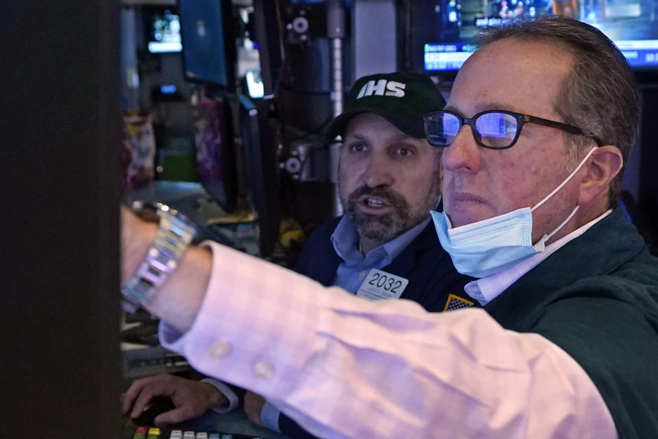 Specialists James Denaro, left, and Glenn Carell work at a post on the floor of the New York Stock Exchange, Thursday, Oct. 14, 2021. Stocks are moving broadly higher in early trading on Wall Street as the market builds momentum a day after breaking a three-day losing streak. (AP Photo/Richard Drew)