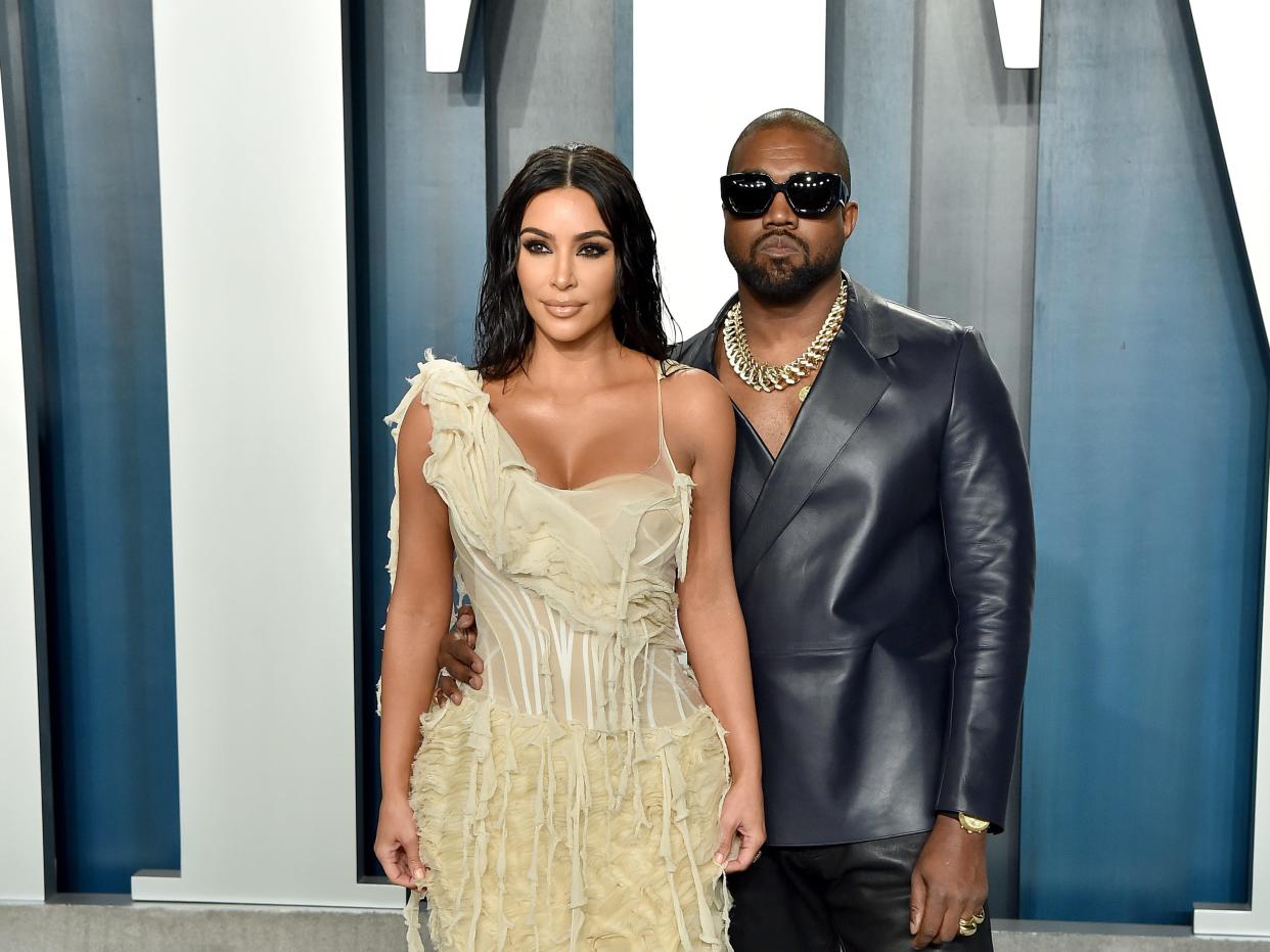Kim Kardashian and Kanye West posing together.