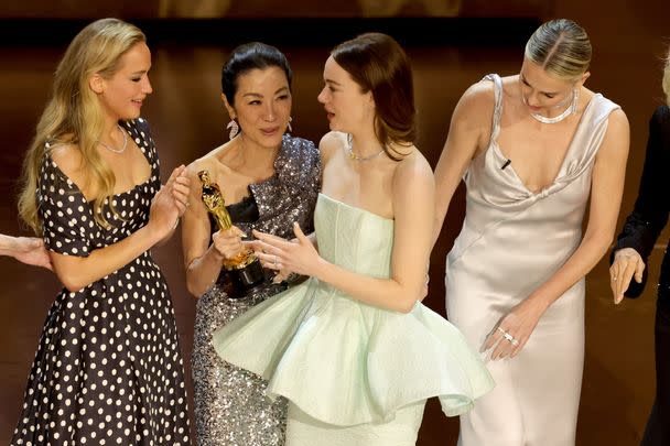 After announcing Stone as the Best Actress winner, Yeoh held onto the Oscar for what appeared to be an unusually long amount of time. Standing to her left were Charlize Theron, and Jessica Lange, and to her right, Jennifer Lawrence, and Sally Field at the end.