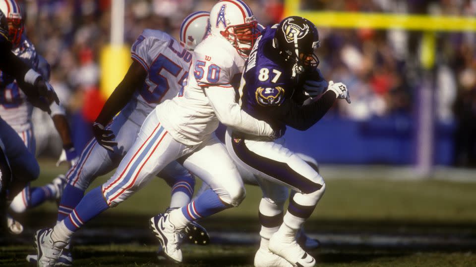Killens tackles Nate Singleton of the Baltimore Ravens during a football game on December 12, 1997. - Mitchell Layton/Getty Images