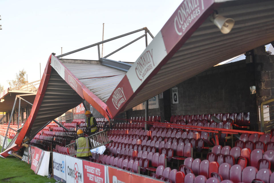 <p>Workmen survey the damage to the roof of Turners Cross stadium, home to the Munster Football Association, and League of Ireland side Cork City, in Irelands southwest city of Cork, on Oct. 17, 2017 after it was blown off in high winds brought by Storm Ophelia. (Photo: Ben Stansall/AFP/Getty Images) </p>