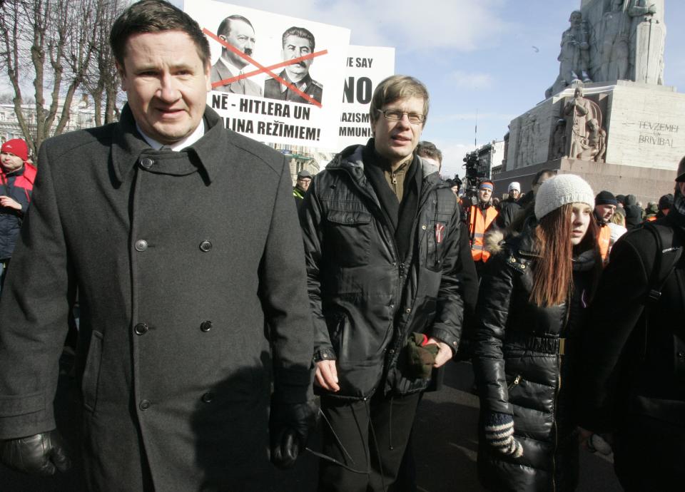 Former Latvian environment minister Einars Cilinskis, center, takes part in a march to the Freedom Monument to commemorate World War II veterans who fought in Waffen SS divisions, in Riga, Latvia, Sunday, March 16, 2014. People participate in annual commemorations of Latvian soldiers who fought in Nazi units during WWII. Einars was formally fired on Friday for rejecting government orders not to participate in annual commemorations of Latvian soldiers who fought in Nazi units. (AP Photo/ Oksana Dzadan)