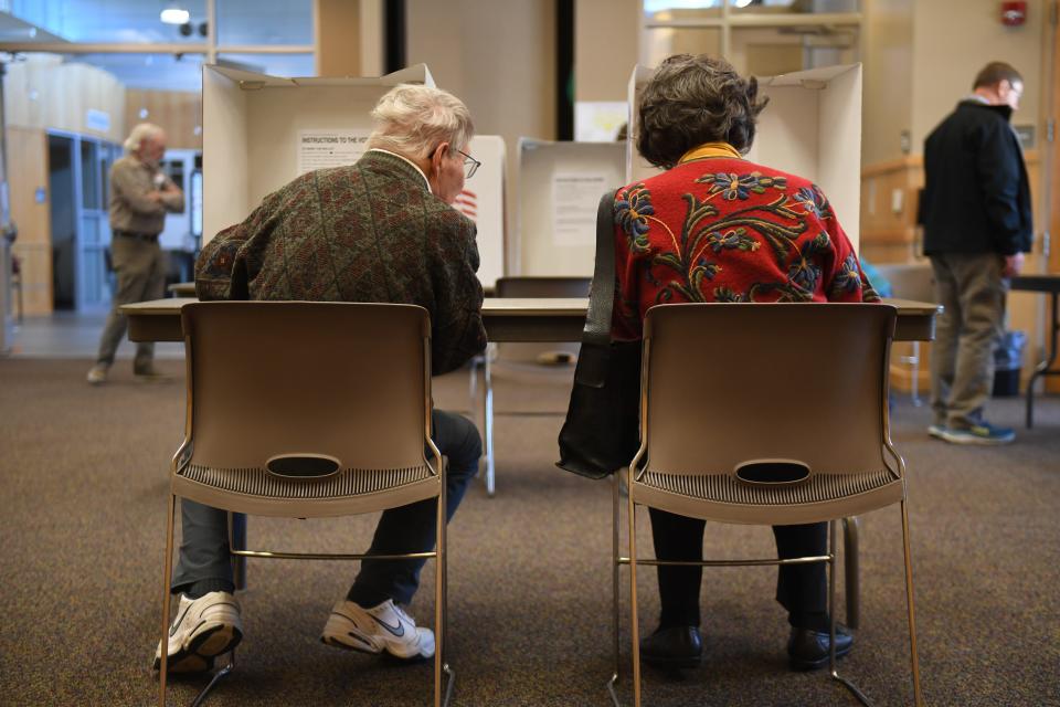 (Left to right) Douglas Pay and Sandra Pay vote next to each other on Tuesday, April 9, 2024 at South Dakota School District in Sioux Falls.