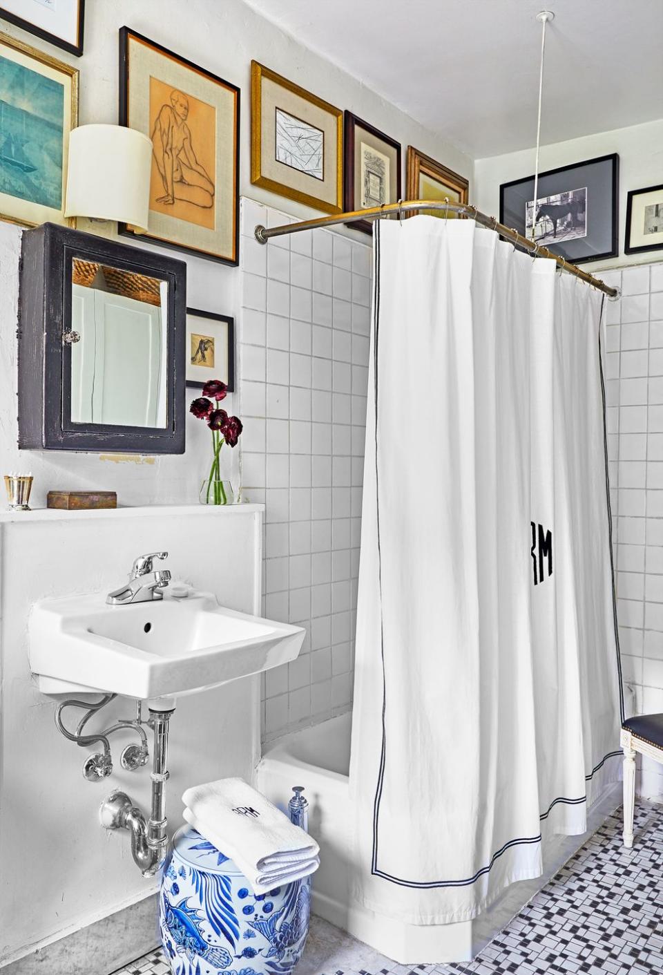 <p>Sure, it might not be the first thing that comes to mind when you think bathroom decor, but what else are you going to do with that otherwise-unused space above your shower? Designer Alexander Reid shows how it adds some much-needed texture to an all-white bathroom (P.S. This is a great design choice for rentals!). </p>