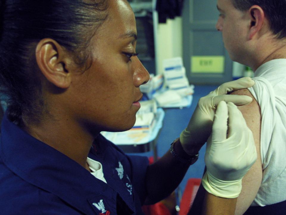 A smallpox vaccine is administered to a sailor on a ship in the Gulf of Aden off the coast of Djibouti