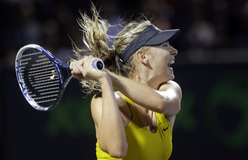 Maria Sharapova, of Russia, returns a shot from Lucie Safarova, of the The Czech Republic, at the Sony Open tennis tournament, Saturday, March 22, 2014, in Key Biscayne, Fla. (AP Photo/Wilfredo Lee)