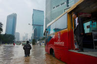People are stranded by floodwaters in Jakarta's central business district on January 17, 2013 in Jakarta, Indonesia. Thousands of Indonesians were displaced and the capital was covered in many key areas in over a meter of water after days of heavy rain. (Photo by Ed Wray/Getty Images)
