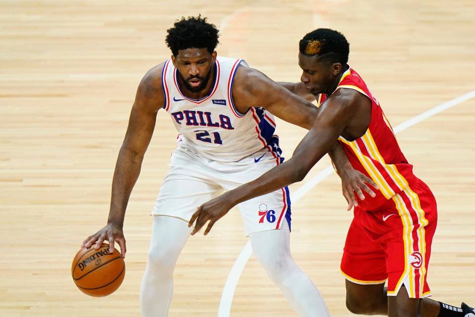 Philadelphia 76ers center Joel Embiid, left, works past the Atlanta Hawks' Clint Capela during an April 28 game.