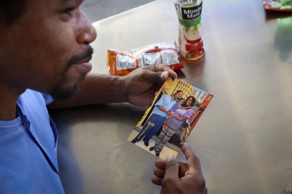 Pharaoh Haywood looks at a photo during a "Get On the Bus" visiting day to Folsom State Prison