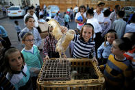 <p>An ultra-Orthodox Jewish boy holds a chicken at the area where people perform the Kaparot ritual, where white chickens are slaughtered as a symbolic gesture of atonement, ahead of Yom Kippur, the Jewish Day of Atonement, in Ashdod, Israel, Sept. 27, 2017. (Photo: Amir Cohen/Reuters) </p>