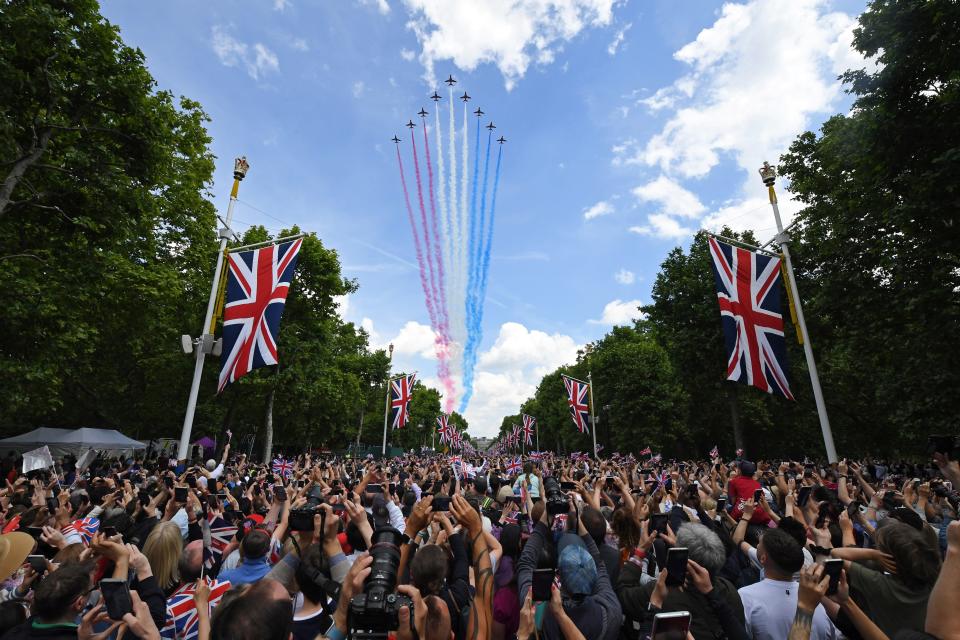 Spectators watch the RAF flypast on The Mall after the Trooping the Colour parade for the Platinum Jubilee of Elizabeth II on June 2, 2022 in London, England.