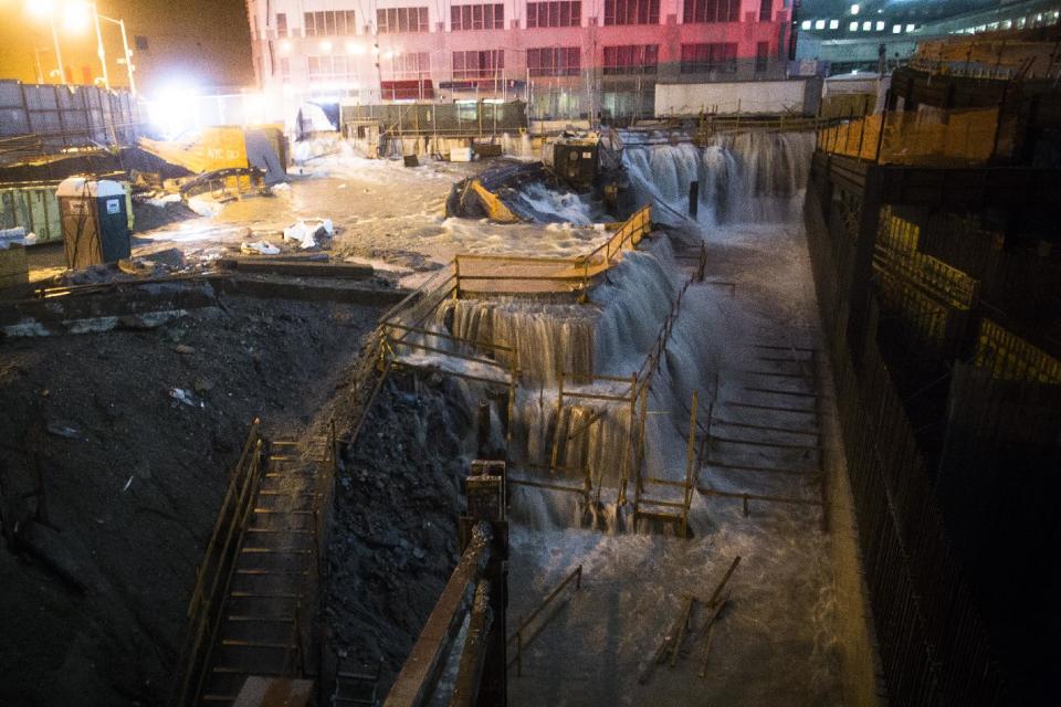 FILE - In this Oct. 29, 2012 file photo, sea water floods the World Trade Center construction site in New York during Superstorm Sandy. Global warming is rapidly turning America the beautiful into America the stormy, sneezy and dangerous, according to the National Climate Assessment report released Tuesday, May 6, 2014. (AP Photo/John Minchillo, File)