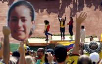 2016 Rio Olympics - Cycling BMX - Victory Ceremony - Women's BMX Victory Ceremony - Olympic BMX Centre - Rio de Janeiro, Brazil - 19/08/2016. Colombian fans celebrate the victory of Mariana Pajon (COL) of Colombia. REUTERS/Eric Gaillard