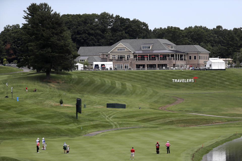 The clubhouse is visible as golfers play through with the absence of fans because of the new coronavirus restrictions during the first round of the Travelers Championship golf tournament at TPC River Highlands, Thursday, June 25, 2020, in Cromwell, Conn. (AP Photo/Frank Franklin II)