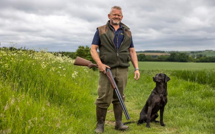 David Peters, a gamekeeper, on the Bartlow Estate in Cambridgeshire with his Labrador, Simba. The estate fears it will have to drastically reduce its number of shooting days - Heathcliff O'Malley for The Telegraph