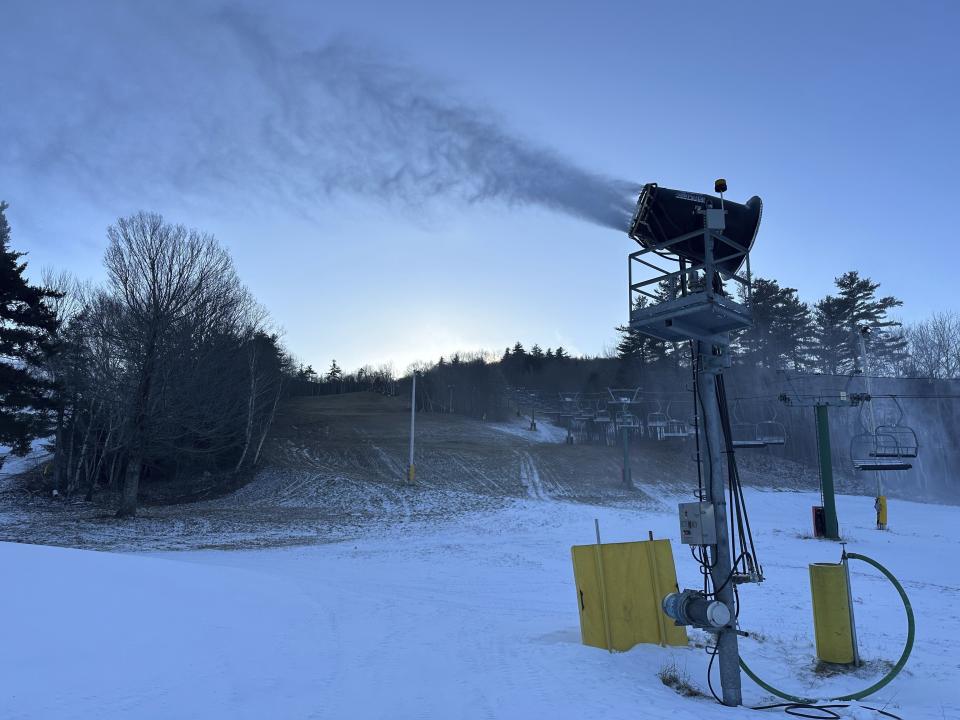 A snowmaking machine at Gunstock Mountain Resort blasts snow on Thursday, Dec. 21, 2023, in in Gilford, N.H. For most Americans dreaming of a white Christmas, this year's prospects aren't good. Although parts of the Rockies and Midwest already have snow or could get a fresh dusting by Monday, other parts of the country that are normally coated in white this time of year are still sporting their drab late-fall look. (AP Photo/Nick Perry)
